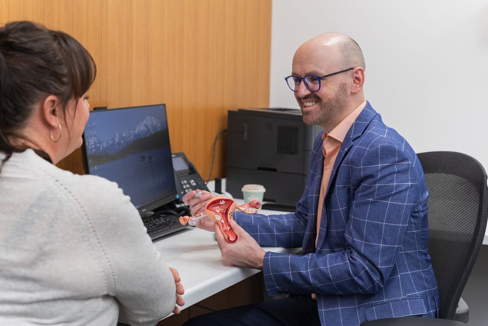 Dr Sam Holford using a uterus model to discuss fibroids